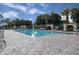 Community pool with lounge chairs and patio area at 3614 Kingswood Ct, Clermont, FL 34711