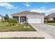 Single-story house with a two-car garage and well-maintained lawn at 3640 Mount Hope Loop, Leesburg, FL 34748