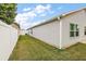 Backyard view showing a well-maintained lawn and vinyl siding at 4056 Venetian Ln, The Villages, FL 32163