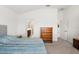 Main bedroom with dresser, en-suite bathroom access, and carpet flooring at 4056 Venetian Ln, The Villages, FL 32163