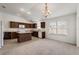 Spacious kitchen with dark brown cabinets and granite countertops at 4056 Venetian Ln, The Villages, FL 32163