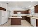 Modern kitchen with island, stainless steel appliances, and light colored countertops at 4056 Venetian Ln, The Villages, FL 32163