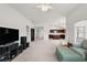 Open living room with view into kitchen and dining area at 4056 Venetian Ln, The Villages, FL 32163