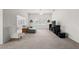 Bright living room with neutral carpeting, ceiling fan, and large TV at 4056 Venetian Ln, The Villages, FL 32163