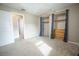 Bedroom with double closets and access to a bathroom at 4566 County Road 116, Wildwood, FL 34785