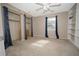 Bedroom with double closets and neutral carpeting at 4566 County Road 116, Wildwood, FL 34785