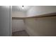 Large walk-in closet with wood shelving and hanging rod at 4566 County Road 116, Wildwood, FL 34785