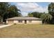 Ranch-style home with a large yard and single car garage at 4566 County Road 116, Wildwood, FL 34785