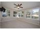 Bright sunroom with multiple windows and ceiling fan at 4566 County Road 116, Wildwood, FL 34785