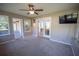 Sunroom with access to patio, ceiling fan, and TV mount at 4566 County Road 116, Wildwood, FL 34785