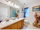 Double vanity bathroom with a shower and window at 4817 Summerbridge Cir, Leesburg, FL 34748