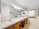 Double vanity bathroom with a large mirror and bathtub at 4817 Summerbridge Cir, Leesburg, FL 34748