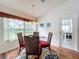 Bright breakfast nook with glass-top table and four chairs, plus backyard view at 4817 Summerbridge Cir, Leesburg, FL 34748