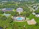 Aerial view of community amenities: pool, tennis courts, and clubhouse at 4817 Summerbridge Cir, Leesburg, FL 34748