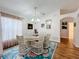 Elegant dining room with round table, six chairs, and a chandelier at 4817 Summerbridge Cir, Leesburg, FL 34748