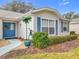 Exterior view showcasing blue shutters and a manicured lawn at 4817 Summerbridge Cir, Leesburg, FL 34748