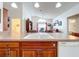 Kitchen island with double sink, dishwasher, and view into living area at 4817 Summerbridge Cir, Leesburg, FL 34748