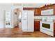 Kitchen features white appliances and wood cabinets at 4817 Summerbridge Cir, Leesburg, FL 34748