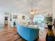 Living room with light teal couch, access to a screened porch at 4817 Summerbridge Cir, Leesburg, FL 34748
