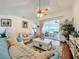 Living room with teal couch and access to a screened patio at 4817 Summerbridge Cir, Leesburg, FL 34748