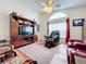 Spacious living room with hardwood floors, comfortable seating and large TV at 4817 Summerbridge Cir, Leesburg, FL 34748