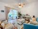 Bright living room with vaulted ceiling, comfy seating, and access to a screened porch at 4817 Summerbridge Cir, Leesburg, FL 34748