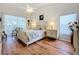 Bright main bedroom with a comfortable bed and ample natural light at 4817 Summerbridge Cir, Leesburg, FL 34748