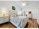 Main bedroom with a queen-size bed and wood flooring at 4817 Summerbridge Cir, Leesburg, FL 34748
