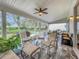 Relaxing screened porch with tiled floor and seating area at 4817 Summerbridge Cir, Leesburg, FL 34748