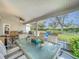 Large screened porch with dining set and backyard view at 4817 Summerbridge Cir, Leesburg, FL 34748