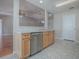 Kitchen with light wood cabinets, stainless steel dishwasher and breakfast bar at 520 Grand Vista Trl, Leesburg, FL 34748