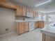 Kitchen with light wood cabinets, tile backsplash, and white appliances at 520 Grand Vista Trl, Leesburg, FL 34748