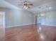 Hardwood floor living room with access to other rooms and entryway at 520 Grand Vista Trl, Leesburg, FL 34748