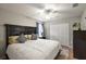 Guest bedroom with a king-size bed, ceiling fan, and double doors at 5312 Galley Way, Oxford, FL 34484