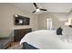 Primary bedroom with a large TV, ceiling fan and plenty of space at 5312 Galley Way, Oxford, FL 34484