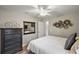 Bright bedroom with a dresser, mirror and ceiling fan at 5312 Galley Way, Oxford, FL 34484