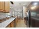 Modern kitchen with granite countertops and stainless steel appliances at 5312 Galley Way, Oxford, FL 34484