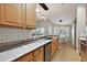 Kitchen with granite countertops, stainless steel appliances, and light wood cabinets at 5312 Galley Way, Oxford, FL 34484