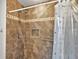 Shower with tiled walls and grab bar at 5312 Galley Way, Oxford, FL 34484
