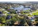 Aerial view showcasing a waterfront community with lush greenery at 5409 Twin Palms Rd, Fruitland Park, FL 34731