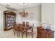 Well-lit dining area with hardwood table and chairs at 5474 Bounty Cir, Tavares, FL 32778