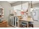 Kitchen with breakfast bar, white cabinets and glass-front cabinets at 5474 Bounty Cir, Tavares, FL 32778