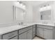 Double vanity bathroom with gray cabinets and quartz countertops at 7531 Far Hills Loop, The Villages, FL 34762