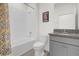 Clean bathroom with shower/tub combo and gray vanity at 8128 Penrose Pl, Wildwood, FL 34785