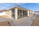 View of home's back and sunroom from the yard at 9224 Se 167Th Ford St, The Villages, FL 32162