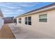 Home's backyard with concrete patio and gravel landscaping at 9224 Se 167Th Ford St, The Villages, FL 32162