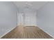 Well-lit bedroom featuring wood-look floors and a double door closet at 9224 Se 167Th Ford St, The Villages, FL 32162