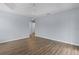 Large bedroom with light walls, wood-look floors, and access to another room at 9224 Se 167Th Ford St, The Villages, FL 32162
