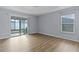 Spacious bedroom with wood-look floors and sliding glass doors leading to a patio at 9224 Se 167Th Ford St, The Villages, FL 32162