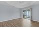 Bright bedroom featuring wood-look floors and access to a private patio at 9224 Se 167Th Ford St, The Villages, FL 32162
